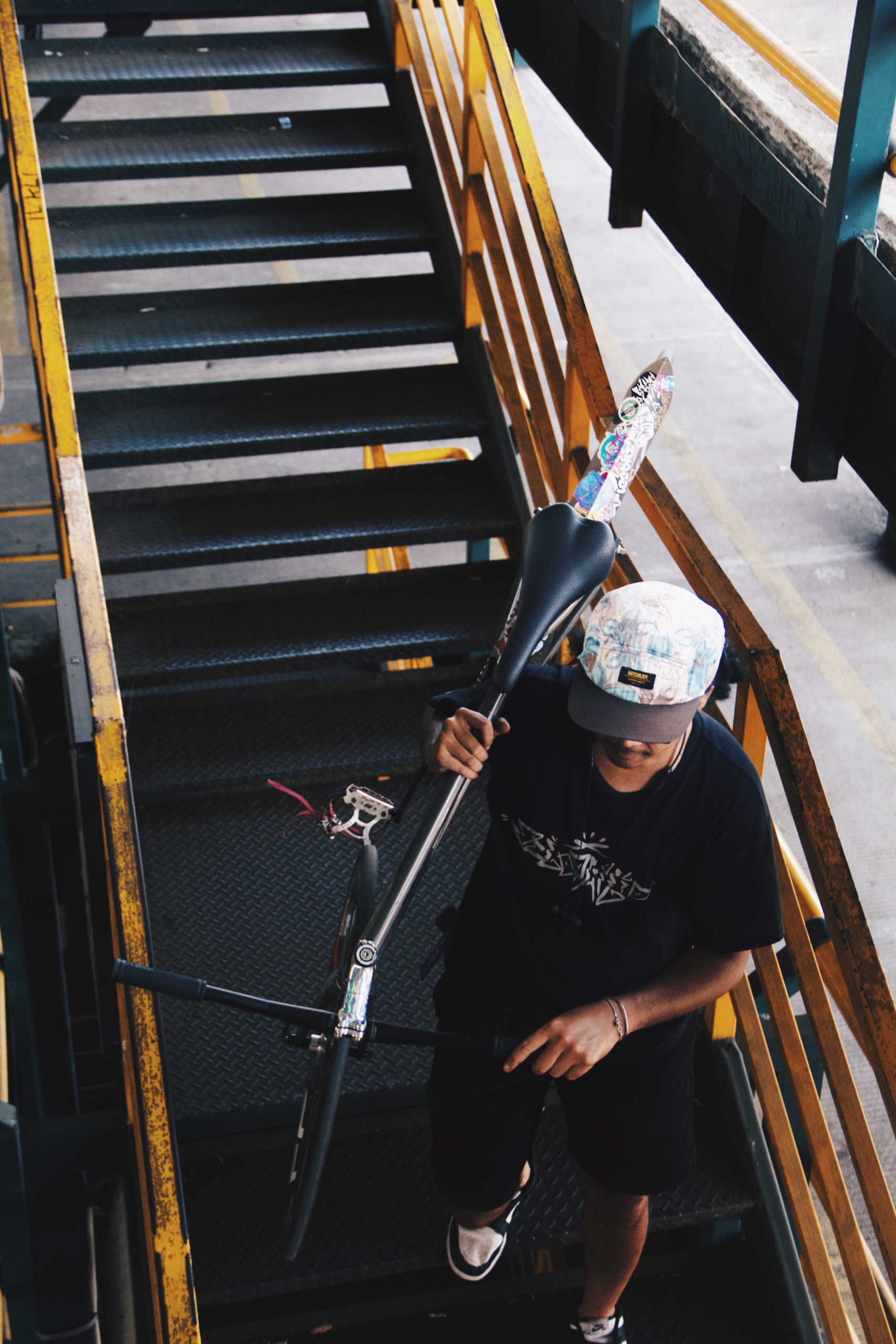 fixed gear cyclist bring him bike trough stairs in abu bakar ali parking lot
